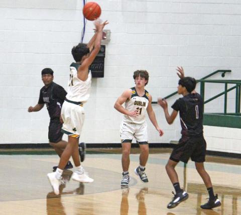 Dublin Lion Kaden Gaitan leaps up to deny a shot at the basket from a Lingleville Cardinal on Nov. 22 in the Roy &amp; Lynn Neff Gym. Gaitan racked up 11 points during the game. Teammate Kevin Patton stands by to assist. Patton put in 8 points during the fight. Paul Gaudette | Citizen staff photo