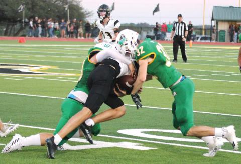Dublin Lions Cooper Pickett and Jacen Hines sweep in from both sides to stop a Brady ballcarrier during Friday night’s home game. Paul Gaudette | Citizen staff photo