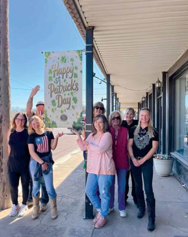 Volunteers with Revitalize Dublin got downtown ready to greet visitors for St. Patrick’s Day by using beautiful spring weather to install new banners. Courtesy photo