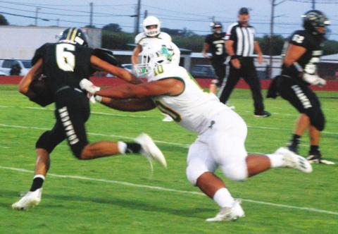 Dublin Lion Mosiah Lolohea lunges to take down a Comanche Indian ball runner during Friday’s away game that resulted in a 26-21 win for the Lions. Paul Gaudette | Citizen staff photo