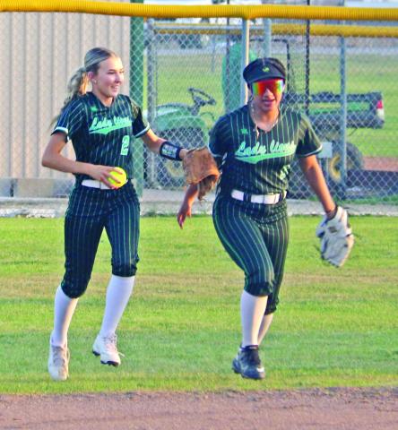 Lady Lions Tylor Nail and Adriana Stewart run in after an out while Regan Vanbebber catches a ball to knock out a Tolar runner before she reaches first base in a home game Tuesday, March 3. Paul Gaudette | Citizen staff photos