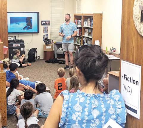 Children and parents lined the walls of the Dublin Public Library teen area back into the fiction stacks as they learned about fearsome, finned fishies in a presentation by Matt “The Shark Guy” on Tuesday, July 11. Paul Gaudette | Citizen staff photo