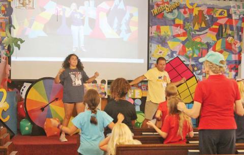 Paul Gaudette | Citizen staff photo Greens Creek Baptist Church is abuzz with color and activity this week as it is hosting the Twists and Turns Vacation Bible School. Students have been led through faith-based and fun dances (above) in the sanctuary and crafts like three-dimensional fish paper crafts (below). Cards and oversized games adorn every part of the church offering fun ways to worship and even showing off some hula hoop tricks (left). The VBS is held 8:45 a.m. to noon through Friday, July 28.