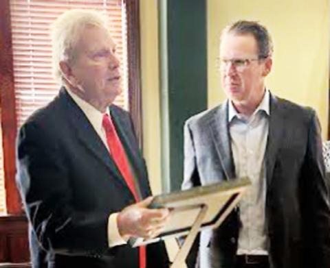 Kent Perkins holds a presentation given at the Aug. 25 Erath County Commissioners Court meeting in honor of his late wife, Ruth Buzzi, known for her comedy and appearances in film and television. The honor was presented by County Judge Brandon Huckabee. | Submitted photo