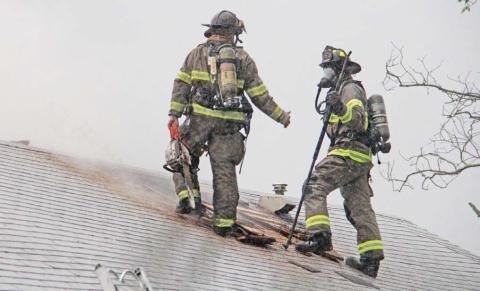 In a torrential downpour Thursday, April 24, Erath Fire/Rescue Firefighter Rocco Fitzgerald and Dublin VFD firefighter JW Brunson work to extinguish a house fire on Camden Street in Dublin. The cause of the fire is undetermined at this time. Dublin VFD, Erath Fire/Rescue, Harbin VFD, Erath County Fire Marshal Tommy Shelton and Dublin PD aided at the scene. The home suffered serious damage but no one was injured. Wyndi Veigel-Gaudette | Citizen staff photo