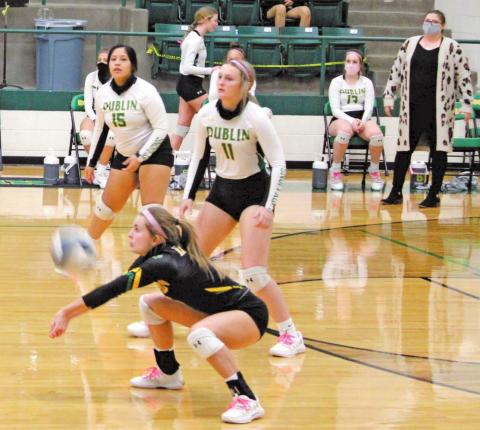 Dublin Lady Lion Rianna Turner digs deep to return a ball as teammates Letty Perez and Kiersten Fincannon stand by to assist during Saturday’s home game against the Comanche Maidens. Sara Gann | Citizen staff photo