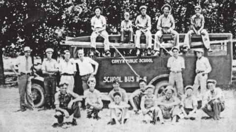 This group of students above was probably on a fund raising trip, harvesting pecans with the cane poles. Comyn was one of the first schools in Texas to have motorized school buses. Motorized buses allowed the State of Texas to close smaller schools and send students to schools with better facilities. Comyn had a rock school (right) that was very nice for a community of its size. This picture was probably taken in the 1930s. | Citizen staff photo