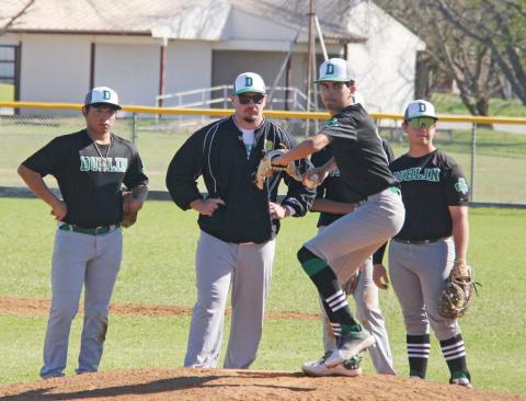 Dublin Lions and assistant coach Dalton Soullas spots for Kaden Gaitan as he warms up to pitch during the DeLeon tournament game against Goldthwaite on Saturday, March 9. Paul Gaudette | Citizen staff photo