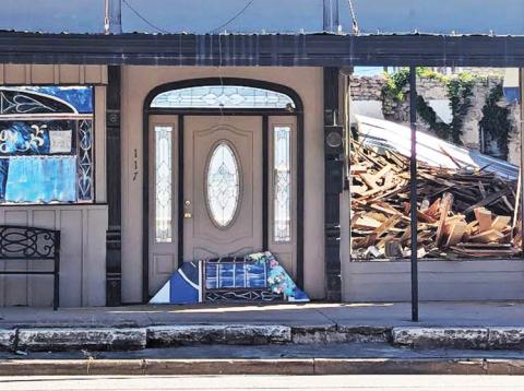The roof of the building next to the Corner Lot collapsed last week leaving a pile of rubble for the owners to sort through and a demolition permit to remove the debris has been applied for. Paul Gaudette | Citizen staff photo