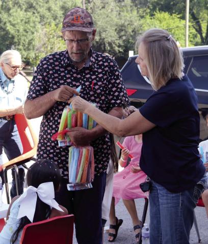 Dublin Rodeo Heritage Museum Executive Director Rick Taylor and volunteer Gaylene Rushfeldt pass out popsicles to children during a tour of the museum. Wyndi Veigel-Gaudette | Citizen staff photo