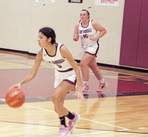 Lingleville Lady Cardinal Araceli Rangel moves the ball up the court while Katelyn Brooks rushes to offer assistance during a home game against Merkel JV on Nov. 22. The game was evenly matched at 10-10 in the first quarter, but Merkel gained ground in the second and took a 36-28 win in the end. Paul Gaudette | Citizen staff photo