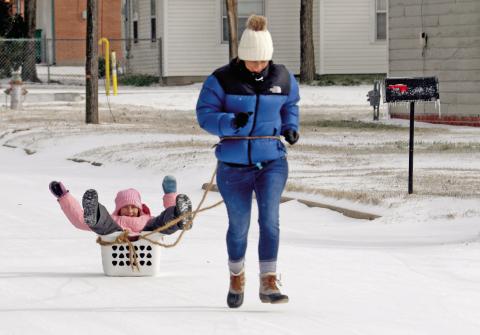 Chelsea Veldhuizen and her daughter, Adeline, play in the cold weather Sunday, Jan. 25 after snow and ice blankets the entire area. For more snow fun photos see page A4 and The Dublin Citizen Facebook photo. Wyndi Veigel-Gaudette | Citizen staff photo
