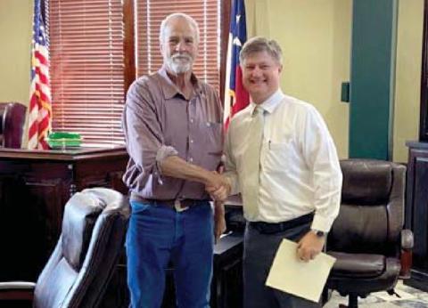 District Attorney Alan Nash receives a 10-year service award from Erath County Commissioner Albert Ray. Submitted photo