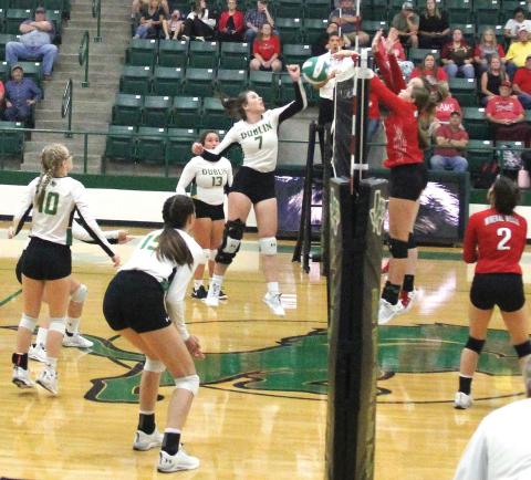 Dublin Lady Lion Madison Turley leaps to meet a Mineral Wells Ram at the net in an Aug. 16 home game.