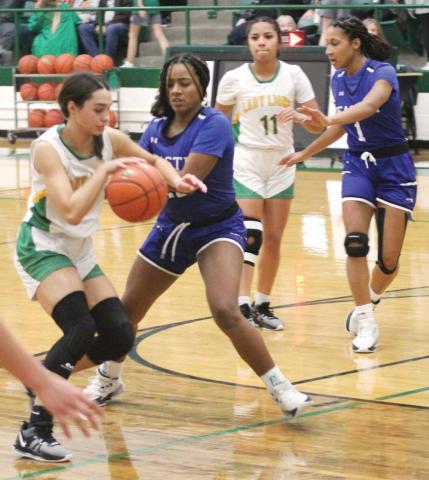 Lady Lion Olivia Salyer edges past Peaster Greyhound defense while teammate Adriana Rosalez tries to break free of a defender to help. Paul Gaudette | Citizen staff photo