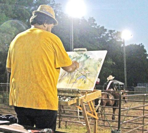  A spectator uses Saturday’s Monta de Toros rodeo at the Dublin City Park arena as inspiration for a painting 