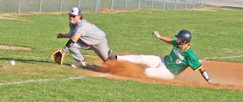Dublin Lion Caden Vanbebber kicks up dust as he slides to safety at third base while an Early player runs to retrieve the ball in the April 11 game on the Dublin diamond. Paul Gaudette | Citizen staff photo