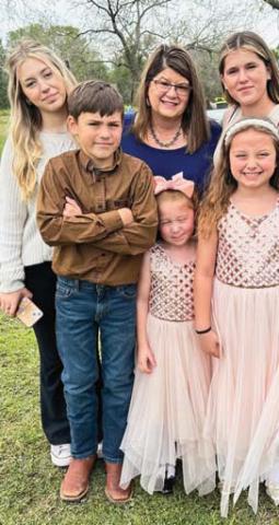 Rachel Maddry stands with her five kids that still live at home. The mom of 11 plus three bonus girls that were fostered as teens or adopted as adults is seeking the community’s assistance as she battles thyroid cancer. Paul Gaudette | Citizen staff photo