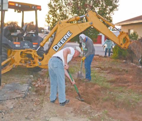 Volunteers Ben Pate and Pat Leatherwood dig a ditch to divert rainwater from the Dublin Senior Citizen Center at 202 E. Clinton last week. The Center is hosting a bake sale at the Dublin Farmer’s Market on Saturday and seeking donations to help with needed foundation repair and drainage issues. Paul Gaudette | Citizen staff photo