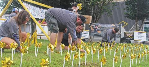 Organizers with the Rylan Strong Network place gold pinwheels in the Corner Lot in honor of Childhood PageA8 CancerAwarenessMonthinSeptember.ThereisafundraiserforthenonprofitatthelibrarythisSaturday. Paul Gaudette | Citizen staff photo