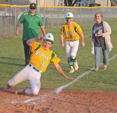 Cameron Patton and Kevin Patton (above) show off their competitive side as they slide to home plate during their final ‘walk’ around the bases following the April 23 home game. Charlie Rasberry (below) is presented with mementos during the senior night presentation that preceded the game. Paul Gaudette | Citizen staff photo