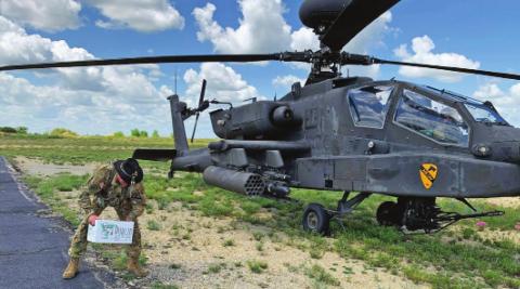 US Army Major Justin Huckabee loads a box of Dublin Bottling Works sodas onto an Apache helicopter he flew in to Dublin Airport as part of his official final flight on July 7. The sodas were handed out at the hangar at Fort Hood when he returned (below, left) and met up with his wife, Ashley, and children, Josh and Jaci. Brad Stanford and Ashley Huckabee | submitted photos