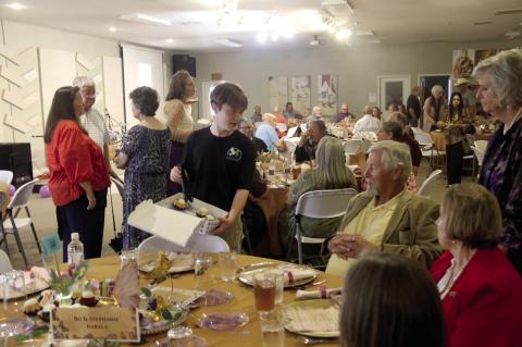 Volunteer Paul Adams offers a selection of mini bundt cakes at the inaugural Society for the Innocents banquet held at Cottonwood Church Thursday, May 14. Society for the Innocents will be opening St. Anne’s House at the former Golden Age Manor location. The banquet served as the nonprofit’s first fundraising effort. Paul Gaudette | Citizen staff photo