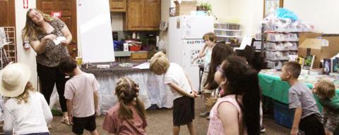 Insructor Sarah Warner Svadlenka leads students in the Dublin Public Library music camp July 10-14. In the photo above, kids are tasked with moving their heads to match musical tones. Wyndi Veigel | Citizen staff photo