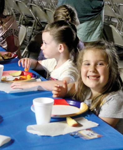 Participants enjoy a meal of apples, grilled cheese sandwiches and cheese poofs at the Double N Cowboy Church’s VBS held June 16-19. The True North-themed VBS featured crafts, games, meals, music, fun and lessons about Jesus. Wyndi Veigel-Gaudette | Citizen staff photos