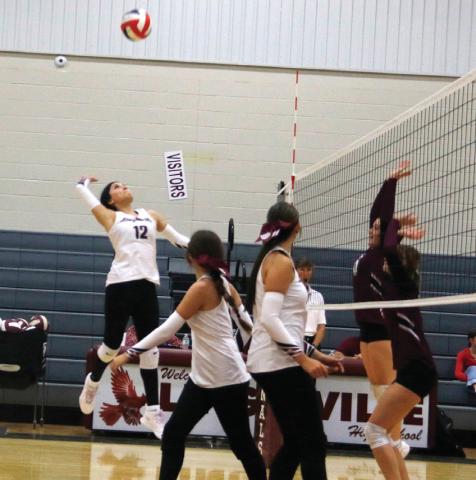 Lingleville Lady Cardinal Denise Toledo leaps up to smack the ball back against Zephyr in a home game Tuesday, Aug. 19. Paul Gaudette | Citizen staff photo