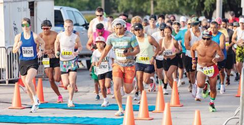 Runners bolt through the starting line near the Dublin Public Library during the Irish Stampede hosted by the Lions Club Saturday, June 14. Danielle Meador | Citizen staff photo