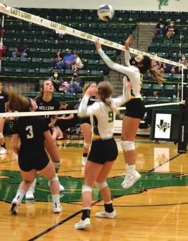 Dublin Lady Lion Kylie Olvera takes to the air to return a ball during Saturday’s home game against the Millsap Lady Bulldogs while Madilyn Loper stands by for coverage. The game resulted in a four-set loss for the home team. Paul Gaudette | Citizen staff photo