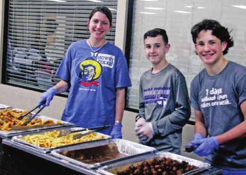 Smiling volunteers (above) stand ready to serve up fresh fried catfish, fries and hushpuppies in the return of the annual Knights of Columbus Lenten Fish Fry Friday at Newman Hall in Stephenville. Meanwhile in the kitchen (below), the professionals keep cooking. Paul Gaudette | Citizen staff photo