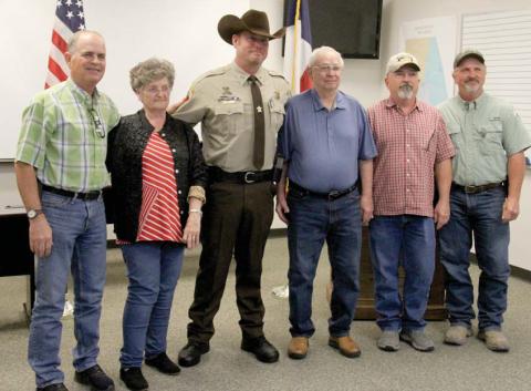 Erath County Sheriff’s Office Sgt. Chris Hill, center, is thanked by Jimmie and Carolyn Green and their three sons after the Greens were saved from a house fire by the deputy. He recently received the lifesaving award from Erath Sheriff Matt Coates. Wyndi Veigel | Citizen staff photo