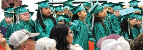 Young grads garbed in gowns