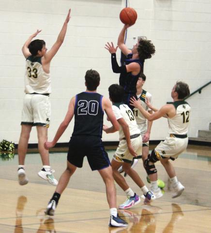 Dublin Lion Dane Lewis leaps up to block a Peaster Greyhound during the Tuesday, Dec. 19 home game while Alex Teten, Carson Ivie and Kyson Gilman rush in to assist. Paul Gaudette | Citizen staff photo