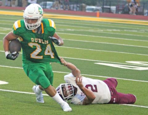 Dublin Lion Jovani Cervantes gets his jersey stretched by a DeLeon Bearcat during the season opener on Cervetto Field Friday, Aug. 30. Paul Gaudette | Citizen staff photo