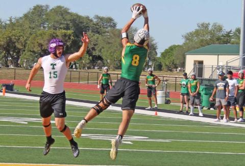 Dublin Lion Aiden Salyer (above) leaps to catch a pass in the endzone over a Tioga blocker while teammates work to keep the ball out of Tioga hands and score. Paul Gaudette | Citizen staff photo