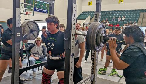 Dublin Lion Jayden Balvantin (above) stacks the weights during the squat portion of the Dublin Invitational Powerlifting Meet while teammates stand by to spot. Annabelle Delgado (below) dips down while coach Hannah Smith drops to check her form and cheer her on. Paul Gaudette | Citizen staff photo