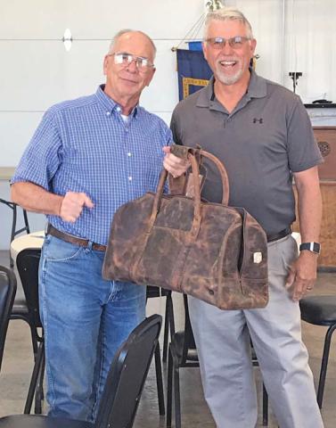 Outgoing Dublin Rotary President Ben Pate was sent packing in style with the gift of a vintage-style bag in honor of his years of service. It was presented by incoming President Pat Leatherwood. | submitted photo