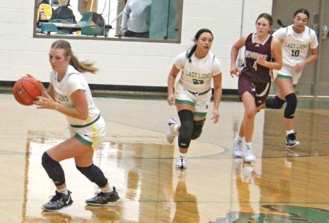 Dublin Lady Lion Derby Kukla pivots to bring the ball back to the net as teammates Haden Keilers and Olivia Salyer rush in from behind. Paul Gaudette | Citizen staff photo