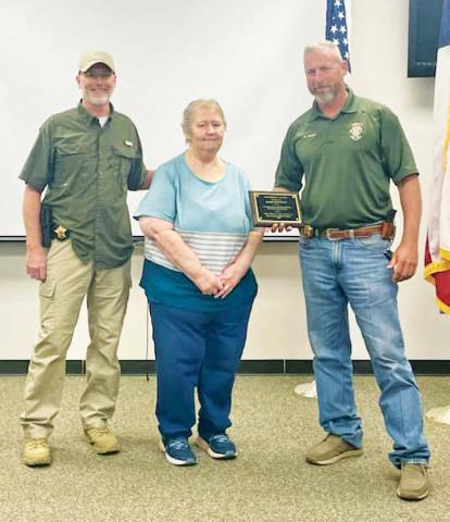 Erath County Sheriff Matt Coates (right) and the Erath County Sheriff’s Office honored Doris McFarlin (center) on Friday, June 30. McFarlin, who is retiring, was recognized for 42 years in law enforcement, serving in the jail and dispatch divisions. | submitted photo