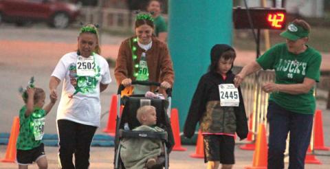 Runners disembark near the Dublin Public Library during the 2025 Shamrock Shuffle 5k held Saturday, March 15 and sponsored by Titan Fitness. Paul Gaudette | Citizen staff photo