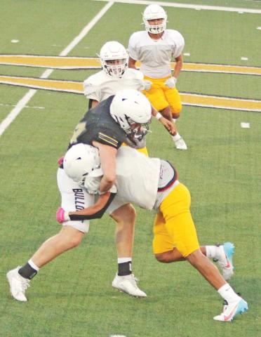 A Dublin Lion connects to bring down a Clyde Bulldog ball carrier during the away scrimmage on Thursday, Aug. 17 as teammate flank in to provide support. Paul Gaudette | Citizen staff photo