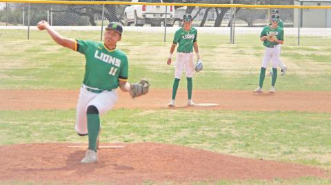 Dublin Lion Joe Salinas pitches from the mound in the Saturday, March 15 game against Peaster while teammates stand by to respond. Paul Gaudette | Citizen staff photo