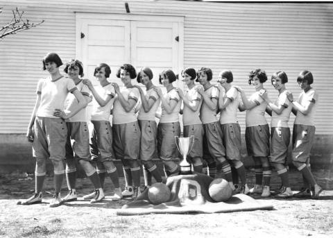 The basketball team of 1925 - 26. Delma Fulford capt ‘26, Mary McBride capt ‘25, Thelma Shaddox jump center, Ora Gilbreath guard and all state ‘26, Delma Warren capt ’28 all state ‘27 forward, Lattie Rackly guard, Mable Whitfield guard, Faye McKinney jump center, Allie Mae Benton guard, Jewell Preston run center, Hazel Hennessee capt ‘27, Violet Phillips forward, (not seen) Miss Cleo Price coach. The gymnasium is seen behind the team. Submitted photo