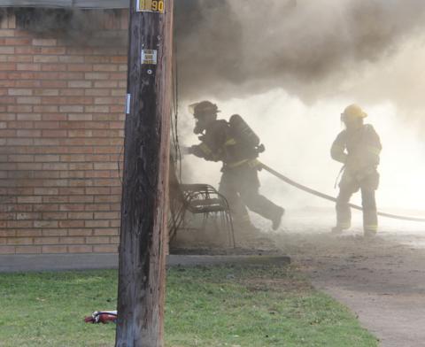 Firefighters battle their way through smoke to enter an apartment on Mesquite Street that was fully involved. As a result of the fire, Jackie Reed, 72, died. Other nearby apartments were impacted through smoke and water damage. Wyndi Veigel-Gaudette | Citizen staff photo