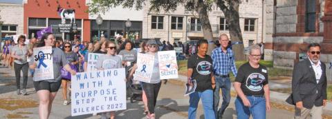 Erath County officials and residents march around the Erath County Courthouse in solidarity with those affected by violence, sexual assault and abuse during the 2022 Stop the Silence rally organized by Cross Timbers Family Services. Paul Gaudette | Citizen staff photo