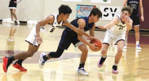 Cardinals vie with a Peaster ballcarrier during a Dec. 3 home game. Paul Gaudette | Citizen staff photo