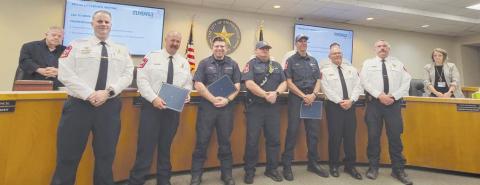 Pictured from left are EMS Chief Steven Jacobsen, Division Chief Chris Elston, FF/EMT Cole Carlin, FF/PM Brent Black, Capt. Cody Wells, Fire Chief Robert Isbell, Division Chief Gregg Schrumpf. Several members who received the award were not present since they had to respond to an emergency call during the city council meeting. Wyndi Veigel-Gaudetee | Citizen staff photo